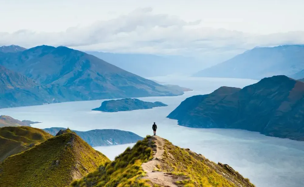 Roys peak mountain hike in Wanaka New Zealand. Popular tourism travel destination. Concept for hiking travel and adventure. New Zealand landscape background.